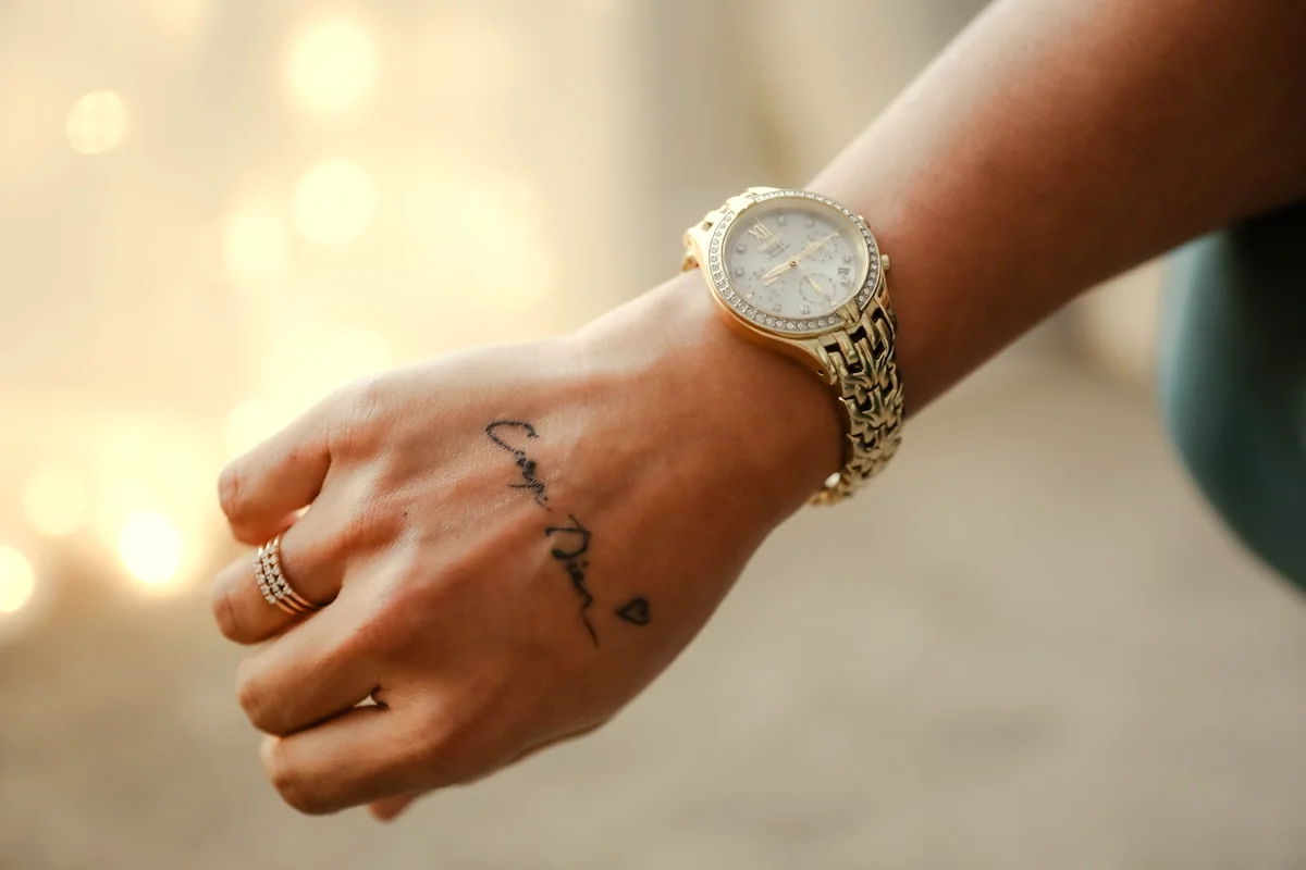 Close-up of bare wrist on cream linen, skin scent editorial still life